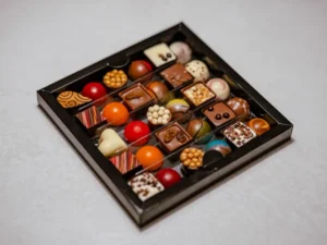 An assortment of chocolates in a dark gift box